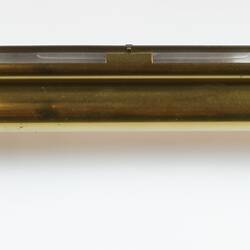 Brass scientific instrument with glass level, overhead view.