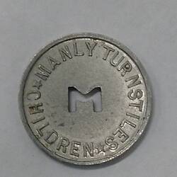 Round coin with M cut out of centre.