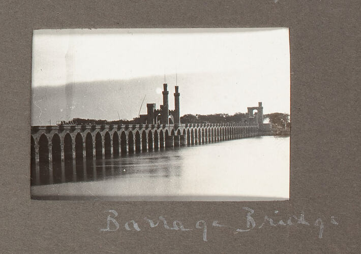 View of bridge over river with multiple arched pylons.