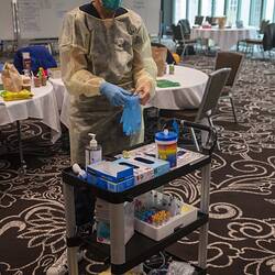 Digital Photograph - Nurse putting on PPE, Hotel Quarantine, Novotel on Collins, Melbourne, 14 May 2020