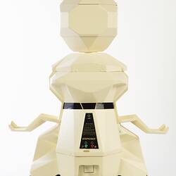 Back view of cream plastic robot with angular human-like shape, ie. head, shoulders, waist and legs. Black plastic features.