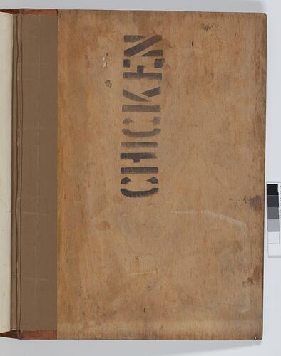 A light brown book cover with the word 'chicken' stencilled in black ink. A darker brown binding lines the rig
