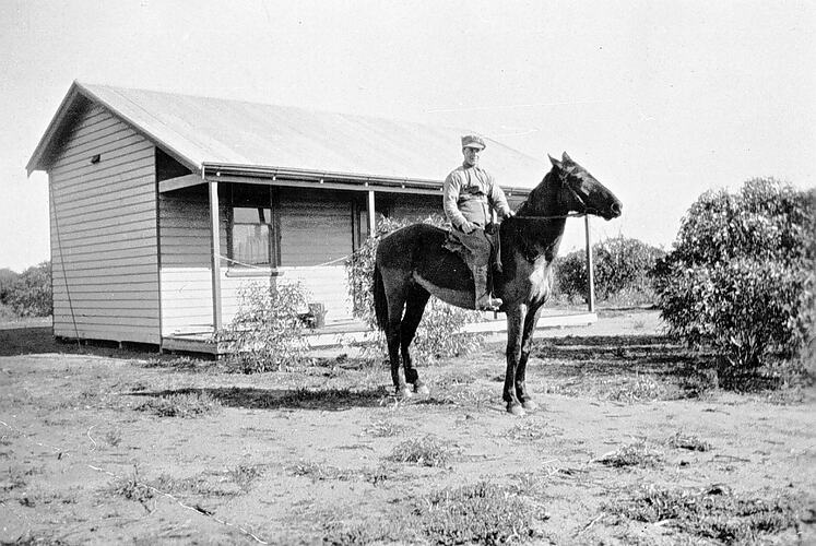 [Dave Larkin on his soldier settlement block, Kooloonong, Mallee, 1923. Larkin is wearing some of his First World War army uniform.]