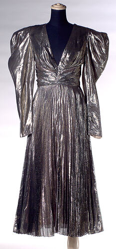 Silver dress with pleated skirt on mannequin.