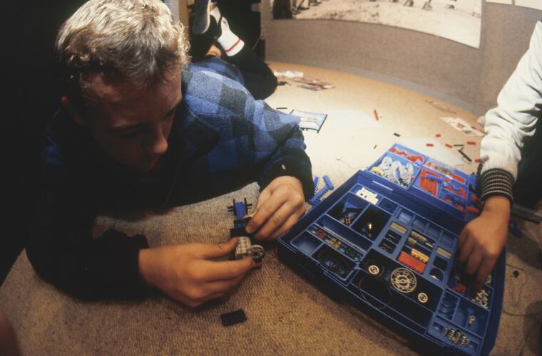 Teacher playing with Lego.