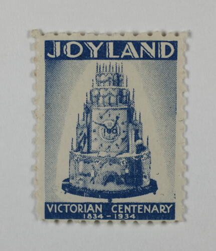 Rectangular stamp with image of a tiered cake in blue ink.