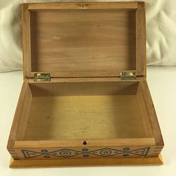 Open timber inlay jewellery box. Geometric patterns in dark and light light brown, blue, yellow, white and red.