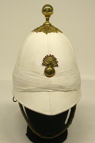 White helmet with ball ornament badge.