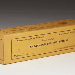 Rectangular cardboard box with yellow-coloured paper label. Label has black printed text.