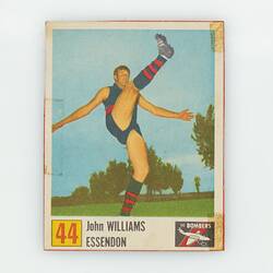 Football card, number 44, with player doing high kick.