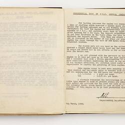 Open book with off white ruled pages. Typed text on right page.