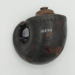 Rounded gun powder flask, wood covered with papier-mache. Wooden stopper & two rings for carriage.