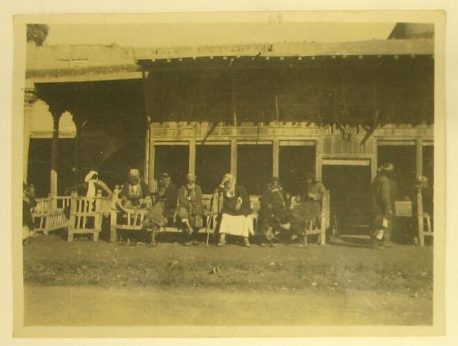 Local people sitting outside coffee shop.