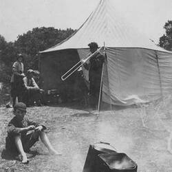 Digital Photograph - Holden Brothers Circus, Man plays Trombone outside 'Tucker Tent', 1900-1910