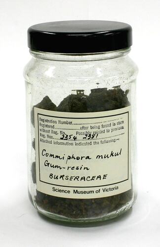Sample of dark coloured resin in labelled jar.