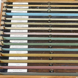 Row of differently coloured paint samples in a box.