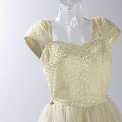 Top half of cream evening dress, yellow sequins.