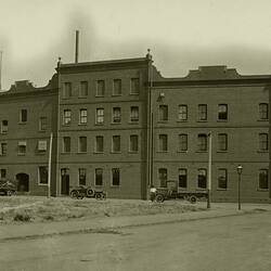 Exterior view of the Abbotsford Kodak factory with delivery trucks in the foreground, taken in the late 1920's.