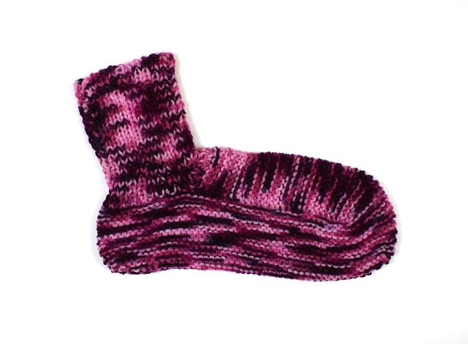 Purple mottled handknitted sock.