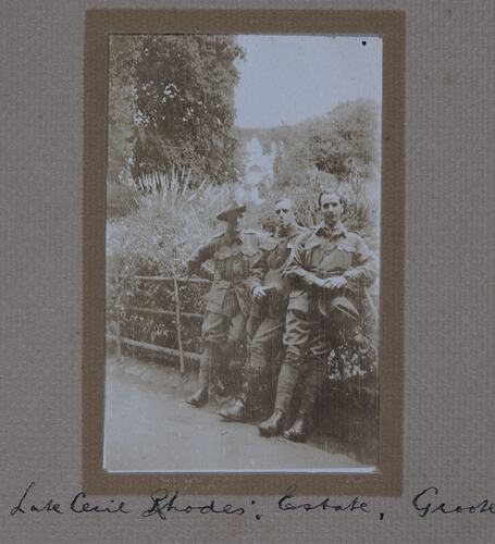 Three men in military uniform in a garden.