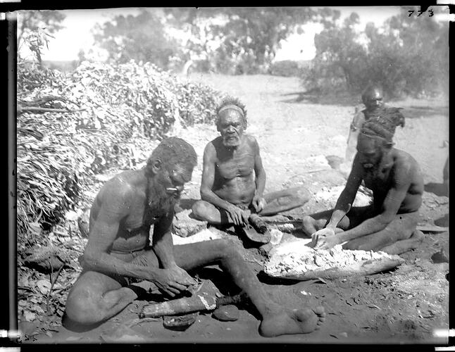 Warumungu man mixing plant down with white pipe-clay in preparation for ceremonial decorations, Tennant Creek, Central Australia, 1901