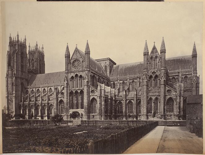 Side of cathedral exterior with two towers visible at entrance.