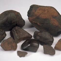 Ten meteorite specimens.