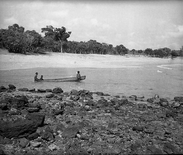 Unidentified men in a canoe, Milingimbi, Northern Territory,  late 1920s-30s