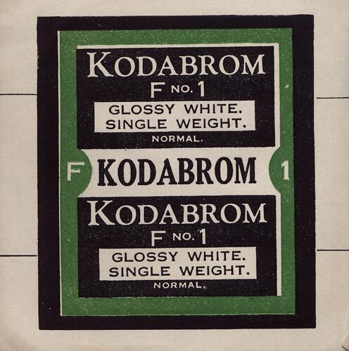 Black and white paper label with green border.