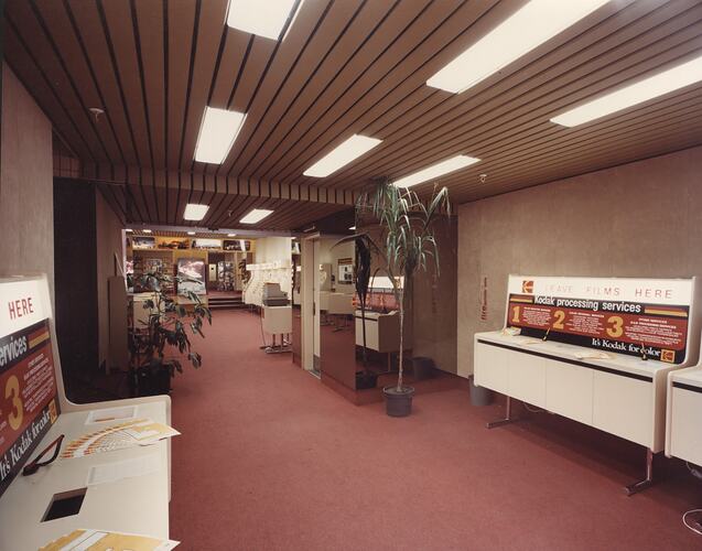 Long, carpeted room with self-service counters.