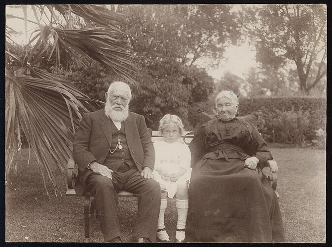 Monochrome photograph of a group in a garden.