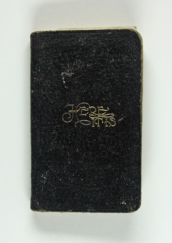 Cover of black book showing gold inscription.