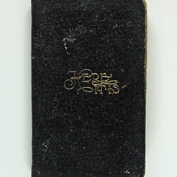 Cover of black book showing gold inscription.