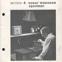 Cover page with photograph of man developing film.