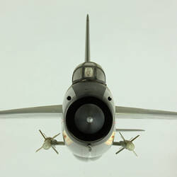 Silver model aeroplane. Front view.