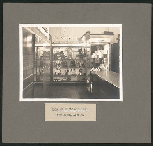 Black and white photograph of a shop interior.