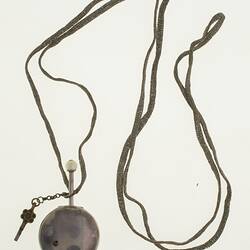 Gentleman's pocket watch in case and attached to silver plaited chain.