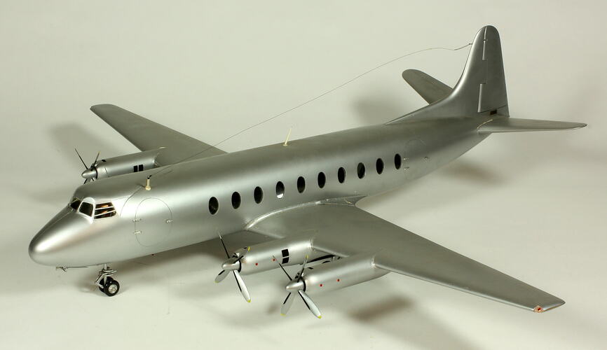 Silver model aeroplane with two propellers on each wing.