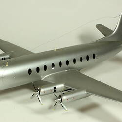 Silver model aeroplane with two propellers on each wing.