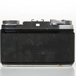 Chrome metal and black leather viewfinder camera. Back view.