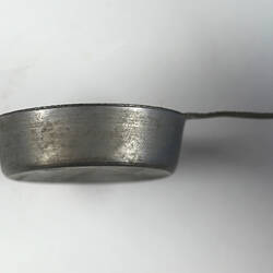 Toy frying pan, side view.