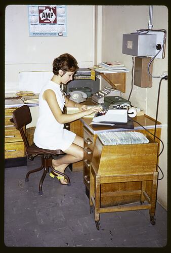 Woman sitting at a desk.