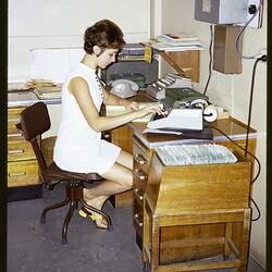 Woman sitting at a desk.