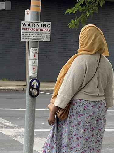 Woman Beside 'Checkpoint Barkly' Sign, Cnr Barkly Street and Summerhill Road, Footscray, 5 Jul 2020