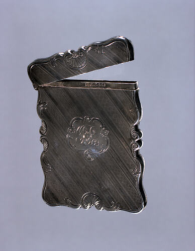 Silver calling card case with monogram and  hinged lid