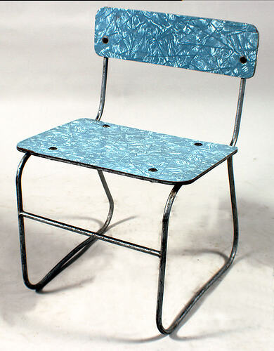 Chair with blue laminex surfaces and metal frame.