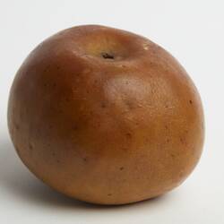Wax model of yellow apple with slight red tinge.