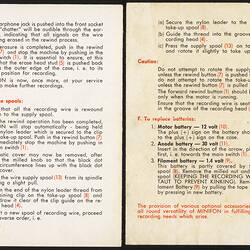 Two open white pages side by side with printed text in black and red.