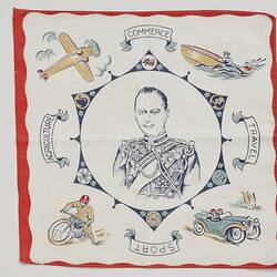 Square white cloth handkerchief. Printed portrait of man in decorative frame in black and red.