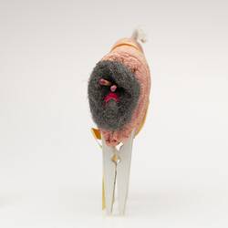 Toy sheep made from folded orange dishwashing sponge, steel wool ball, matches, white pegs.